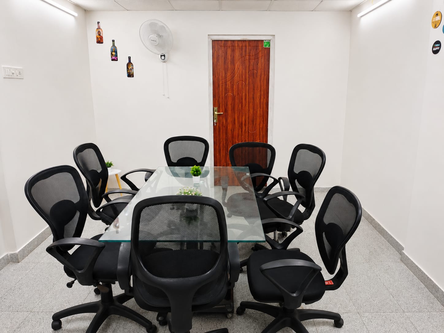 Common area with glass-top table and rolling chairs
