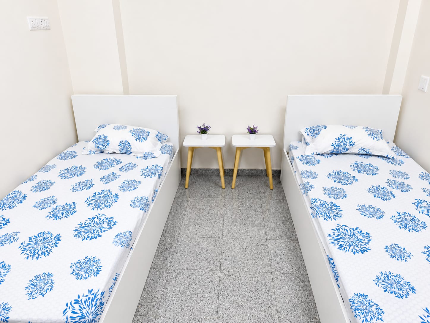4-sharing room with indigo floral bedding and bedside tables